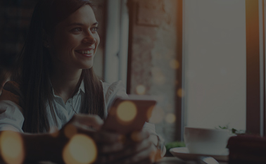 Woman holding phone looking happy